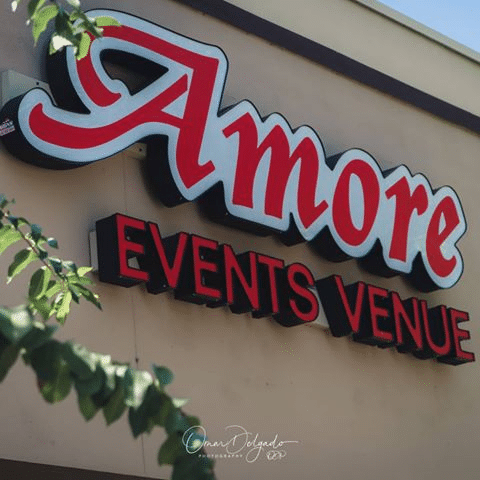 Amore Events Venue red and white sign on tan building